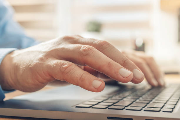 istock Male hands typing on a laptop keyboard, close-up view 1345800457