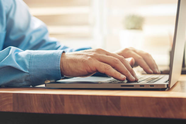 istock Male hands typing on a laptop keyboard, close-up view 1345800460