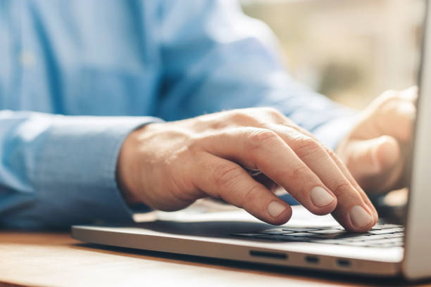 istock Male hands typing on a laptop keyboard, close-up view 1345800461