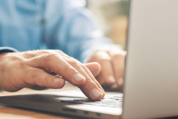 istock Male hands typing on a laptop keyboard, close-up view 1345800464