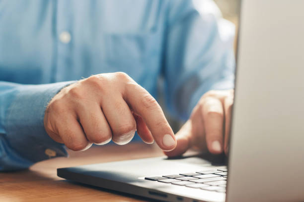 istock Male hands typing on a laptop keyboard, close-up view 1345800470