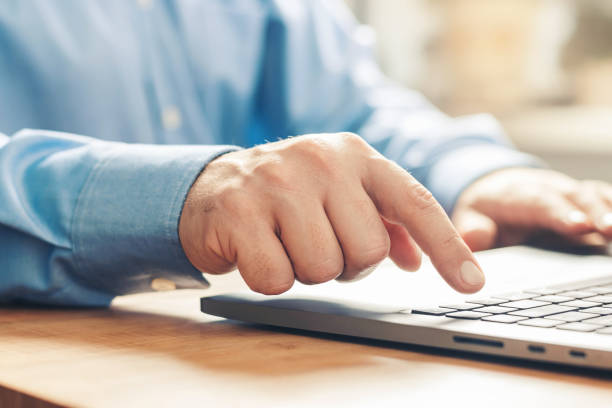 istock Male hands typing on a laptop keyboard, close-up view 1345800485