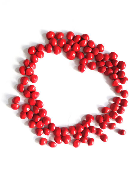 istock heart shape border Saga Seed Acacia beans red in colour 1345800552