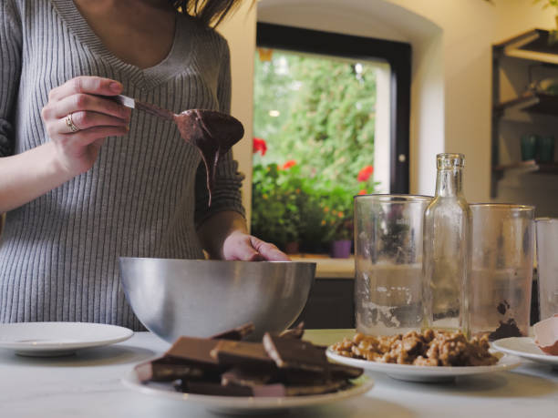 istock Woman cooking a chocolate cake in kitchen 1345801162
