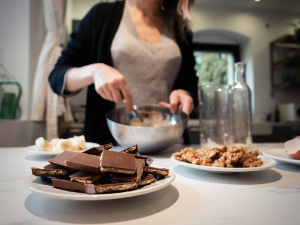 istock Woman cooking a chocolate cake in kitchen 1345801169