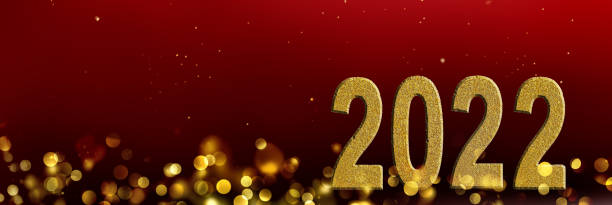 istock golden 2022 number in blur lights and red background 1345801308