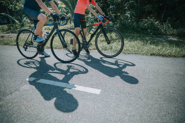 istock low section asian chinese couple cyclist getting ready road biking cycling during weekend morning together at rural scene starting point with shadow 1345803237