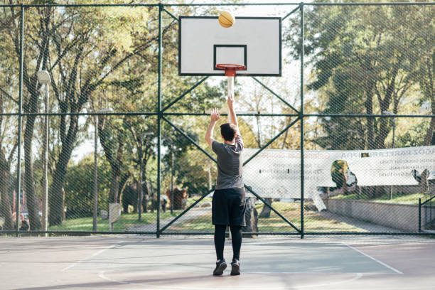 istock Man playing basketball at public park 1345806443