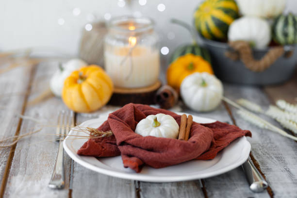 istock Autumn table setting with pumpkins and candles. Zero waste concept, natural elemets. Fall home decoration for festive Thanksgiving family dinner. Wooden table. 1345807517