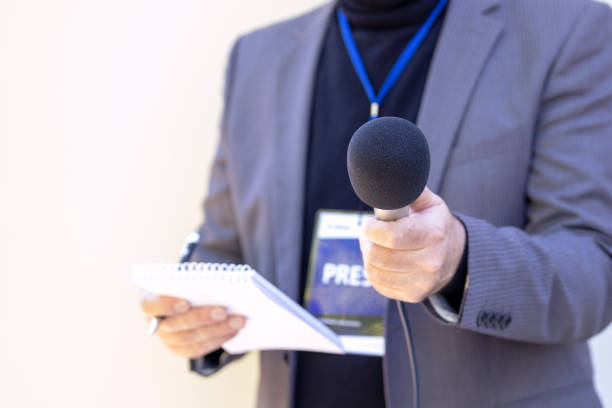 News reporter holding microphone making media interview