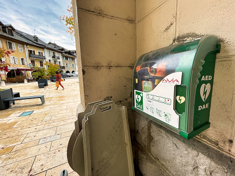 Thones, France - October 04 2021 : a green cpr box with instruments to give heart massage in case of emergency on a public street