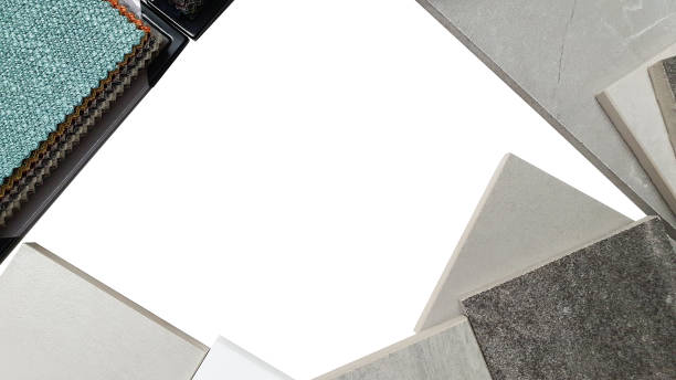 istock white blank space for design surrounded by interior material samples. mood and tone board containing fabric catalog, artificial stones, tiles isolated on white background with clipping path. 1345812702