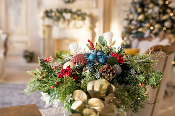 istock living room.Christmas tree, contemporary fireplace , loft interior design apartment. table composition in vase made of fir tree with artificial snow, balls, bows, beads against the festive interior 1345812868