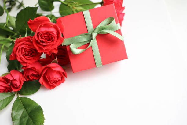 istock beautiful bouquet and a gift box on a white background. 1345813084