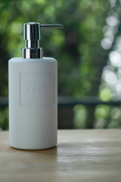 istock White pump bottle on wood table, cosmetic packaging mockup with copy space 1345814868