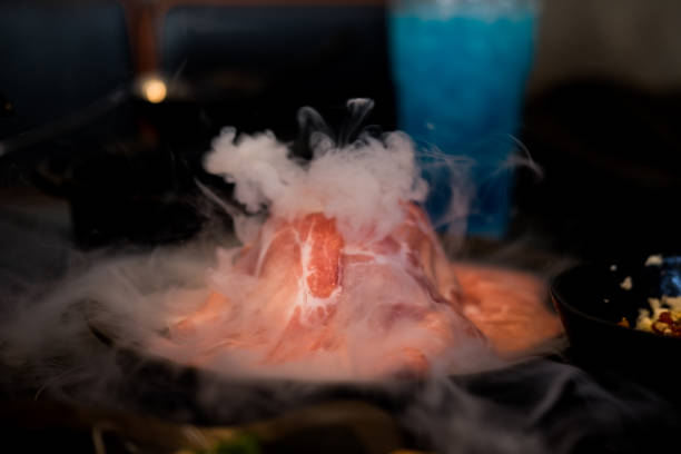 istock Fresh pork slices decoration with dry ice. Close up 1345815042