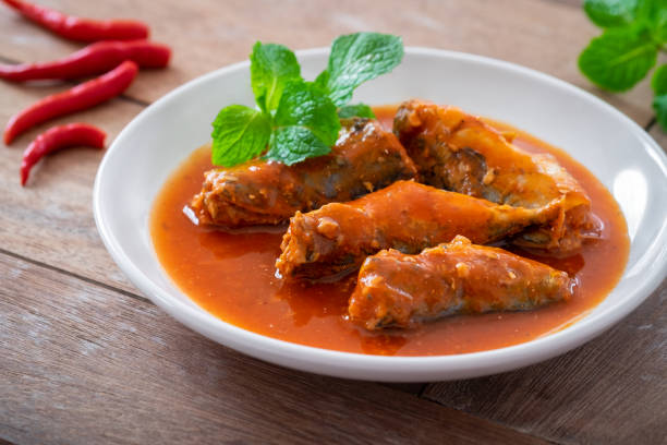 Canned fish in tomato sauce on plate