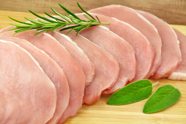 istock Fresh pork meat 10 steaks on wooden board with herbs 1345817668