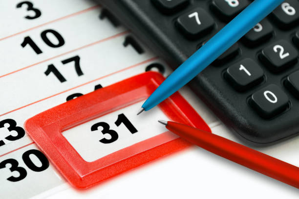 Calendar December 31 and black calculator with red blue pencils Calendar December 31 and black calculator with red blue pencils december 31 stock pictures, royalty-free photos & images