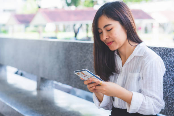 istock close up attractive business woman hands using smartphone tablet typing and touch on screen for working with app devices vintage style in office. 1345818725