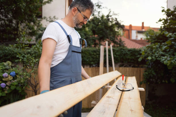 istock Carpenter checking to see if there are some irregularities with timber, after he finished with sanding 1345819588