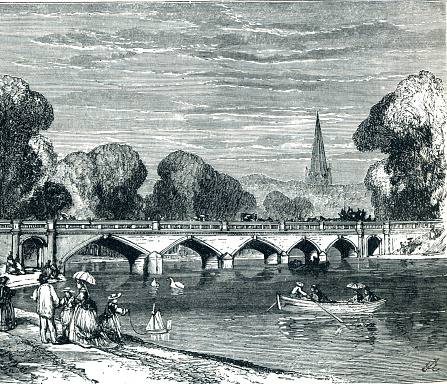 The Serpentine Bridge in Hyde Park. Londoners high society rowing on serpentine lake and parasols toy boats family outing