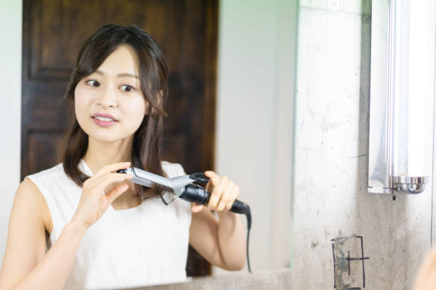 istock A young woman getting her hair styled 1345821746