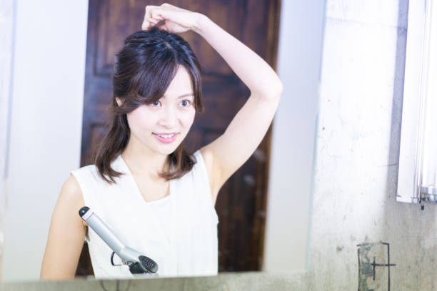 istock A young woman getting her hair styled 1345821748