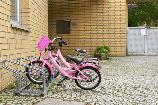 Berlin, Germany – September 13, 2021: parked children bicycles waiting in front of a kindergarten in Berlin