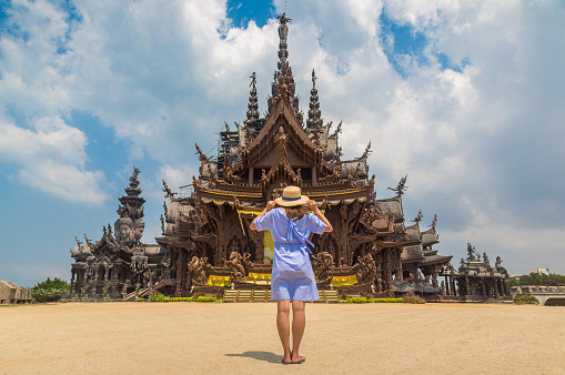 Woman traveler at  Sanctuary of Truth in Pattaya in a summer day