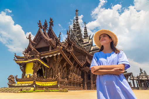 Woman traveler at  Sanctuary of Truth in Pattaya in a summer day