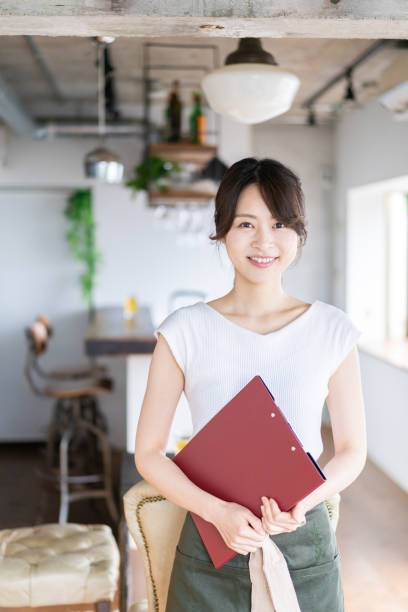 istock Young female staff working at a cafe 1345824367