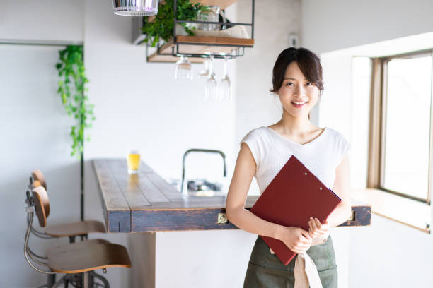 istock Young female staff working at a cafe 1345824369