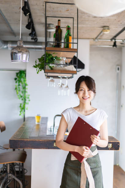 istock Young female staff working at a cafe 1345824372