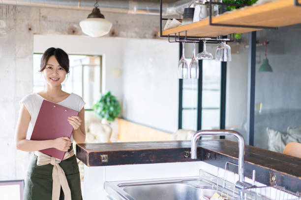 istock Young female staff working at a cafe 1345824373