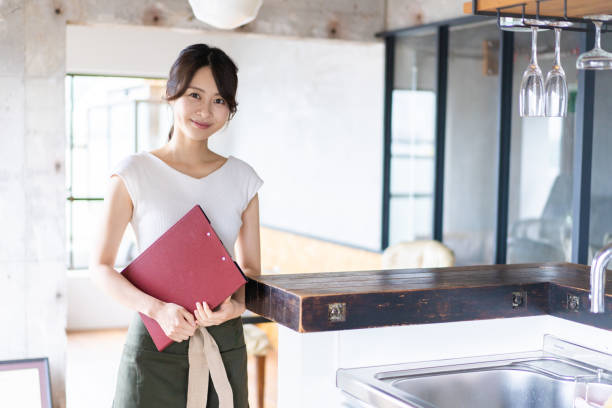 istock Young female staff working at a cafe 1345824375