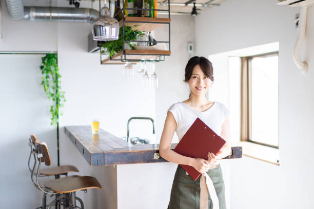istock Young female staff working at a cafe 1345824376