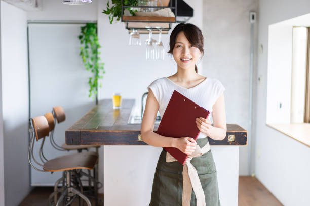 istock Young female staff working at a cafe 1345824381