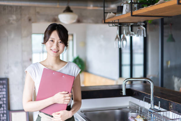 istock Young female staff working at a cafe 1345824382