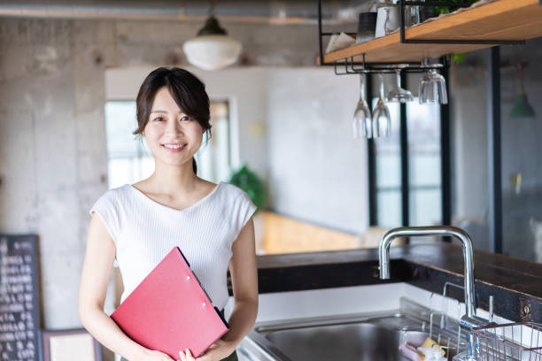 istock Young female staff working at a cafe 1345824396