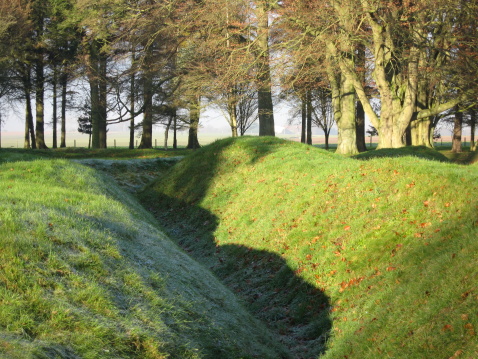 This is a First World War trench (as it can be seen today)in the former front line of the Battle of the Somme 1914 ~ 1918 at Beaumont-Hammel in Northern France. This is a view along the German lines facing the British and allied forces. Taken on a very cold winter morning, note the frost on the left side and the sun on the right side of the trench.It's a very sobering place!