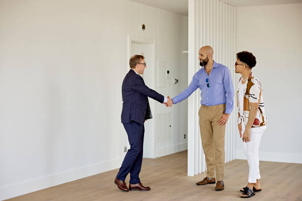 istock Real Estate Agent Shaking Hands with Prospective Buyers 1345826950
