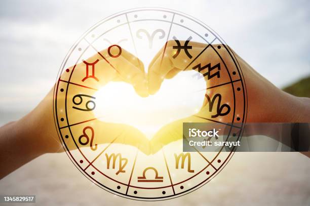 The Hands Of Women And Men Are The Heart Shape With The Sun Light Passing Through The Hands Have Astrological Symbols Stock Photo - Download Image Now