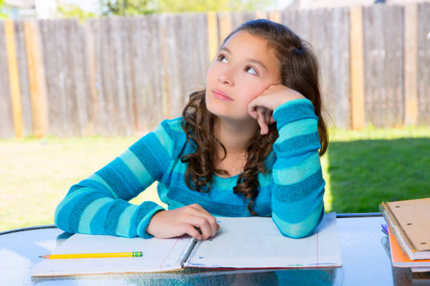 american latin teen girl doing homework on backyard - 2546 imagens e fotografias de stock