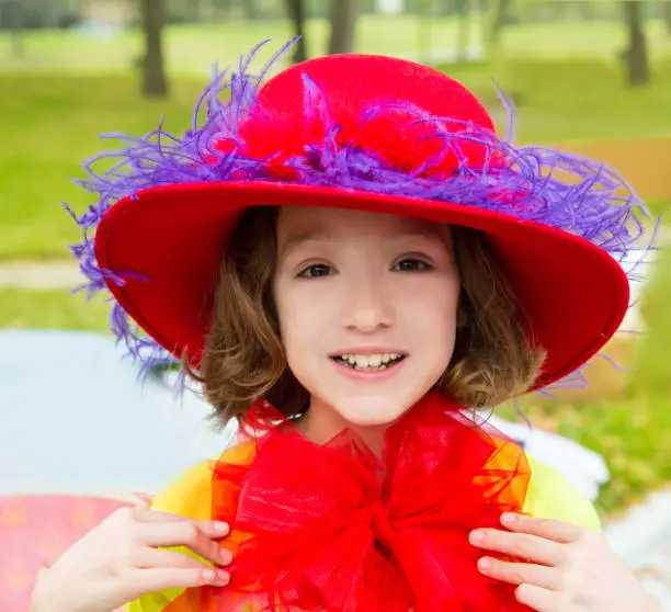 funny little girl with fashion red hat and tulle bow costume