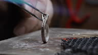 istock Handmade Jewelry making process. Jeweler crafting and cleaning the jewelery. Hardening of gold with fire. Grinding and polishing a gold ring. 1345834382