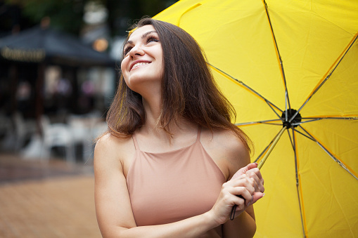 Cheerful young woman holding an umbrella