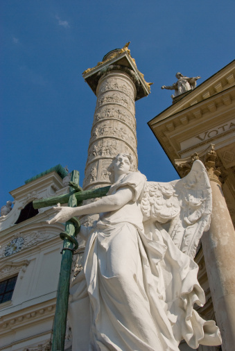 Statue of an Angel with cross and snake with the spiral column