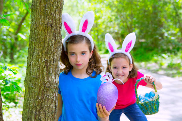 istock Easter girls playing on forest with bunny teeth gesture 1345836542