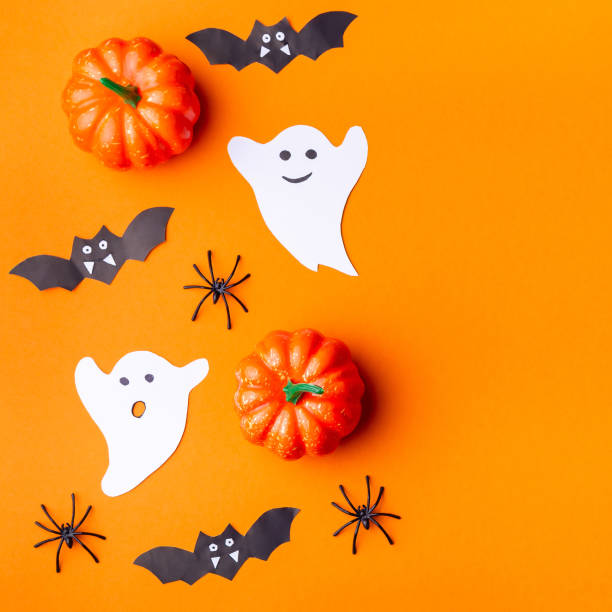 istock Halloween background with spiders, ghosts, bats and pumpkin on orange paper, square 1345836931